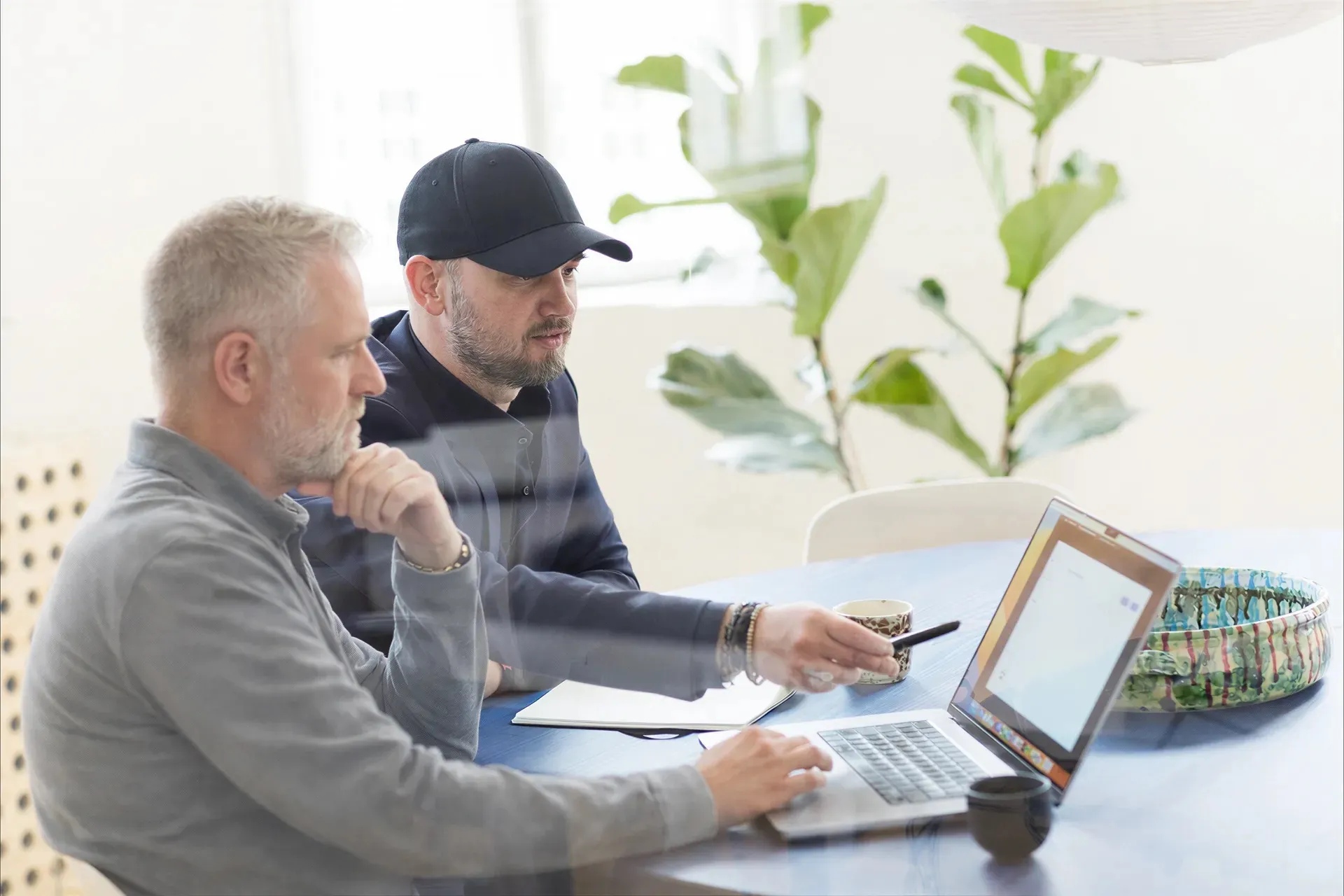 To kolleger gennemgår en henvendelse ved en laptop